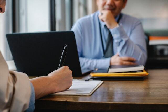 people-at-table-completing screening interview