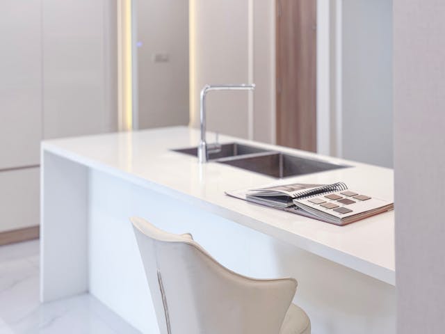 modern-kitchen-with-a-white-countertop-chrome-faucet-double-sink