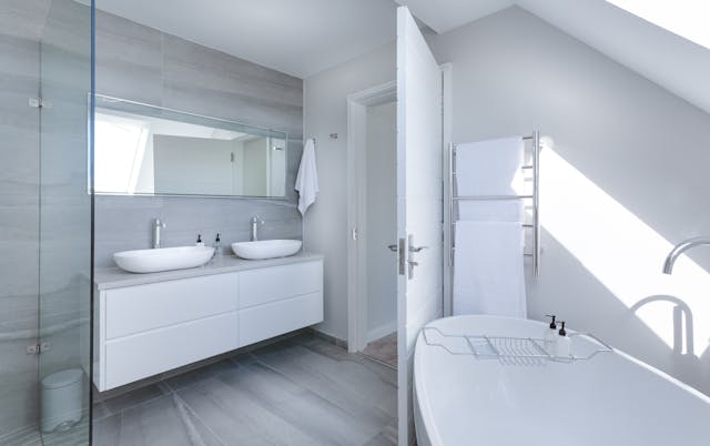 white-bathroom-with-a-white-bathtub-and-silver-fixtures